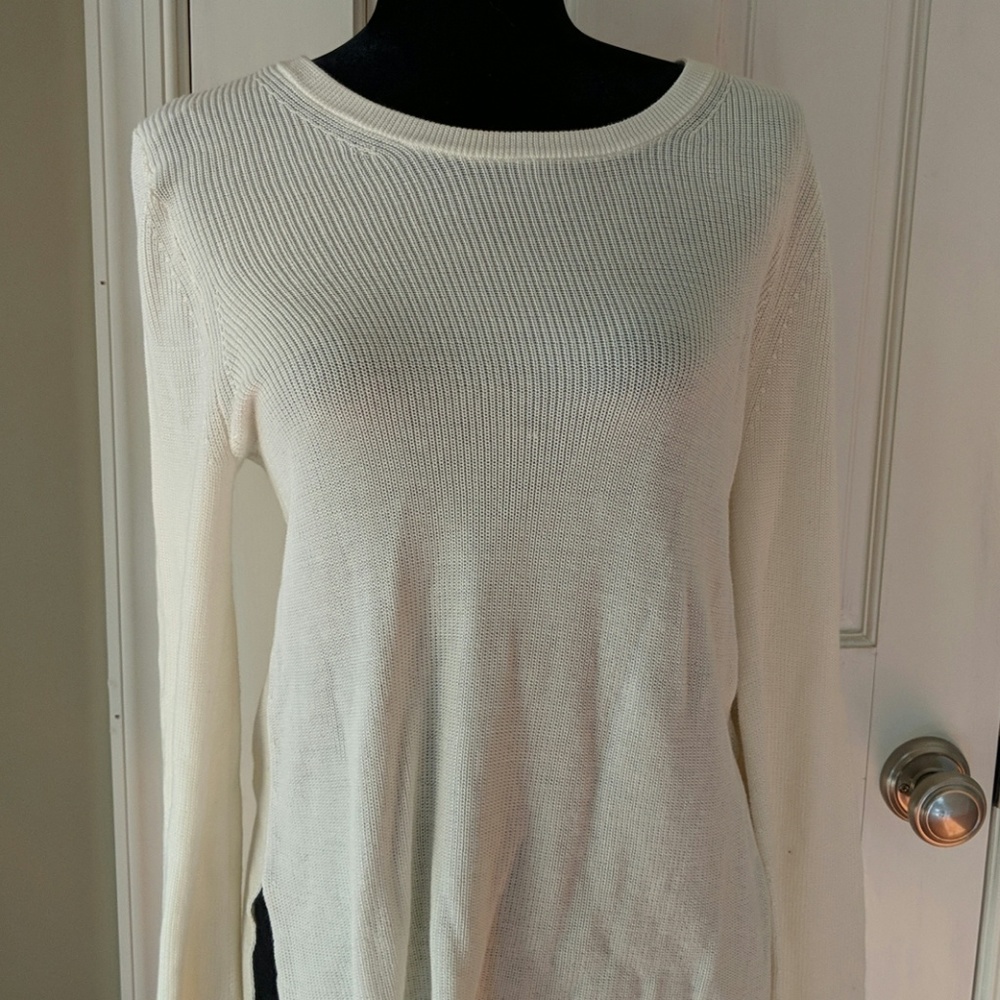 Cream sweater with black detailing in sleeves and
